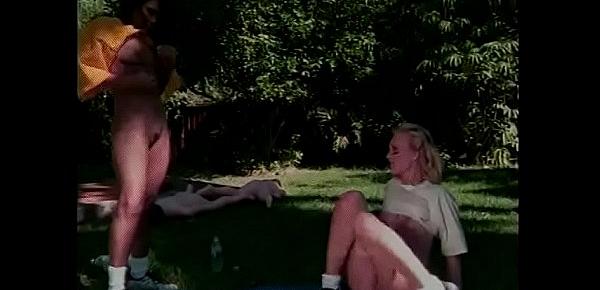  Two lustful chicks with young beautiful bodies caress each other on the lawn